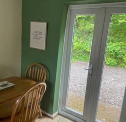 A dining room with a table and chairs at Eirlys Caeathro near Caernarfon