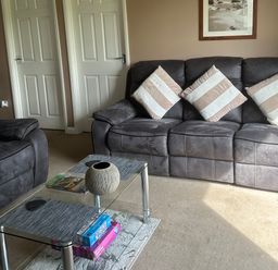 A living room with a sofa and a coffee table at Watergate Bay in Liskeard