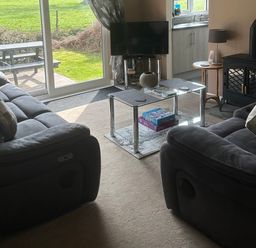 A living room with sofas and a coffee table at Watergate Bay in Liskeard