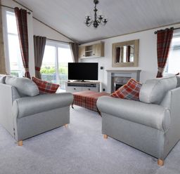 A living room with two sofas and a television at Beachcliff in Porth