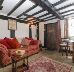 A living room with a sofa and table at Avonmede in Tewkesbury