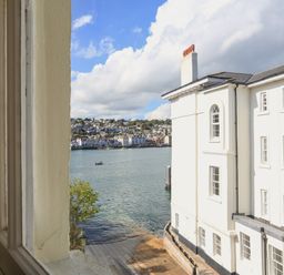 A view of waterfront and buildings across the water from a window at Ferrystone Kingswear near Dartmouth