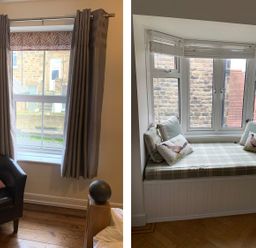 A room with a window with gray curtains and a black chair with a pink pillow and a seating nook with a plaid cushion and bird-patterned pillows at A Stone's Throw in Alnmouth