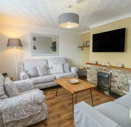 A living room with sofas and a coffee table at Glasfryn in Holyhead