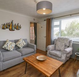 A living room with a sofa and a coffee table at Glasfryn in Holyhead