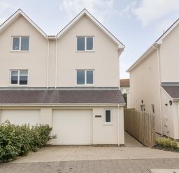Two modern semi detached houses with garages and windows at 3 Lon Y Dryw in Trearddur Bay