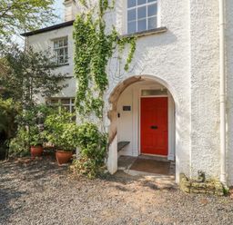 An entrance with a red door and plants at Red Screes in Ambleside