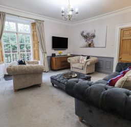 A living room with sofas and a television at Red Screes in Ambleside