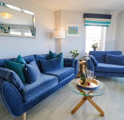 A living room with a sofa and coffee table at Ocean View Apartment in Colwyn Bay