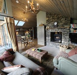 A living room with a fireplace and sofa at The Hare's Shack, Garnett Bridge, Longsleddale. Near Kendal