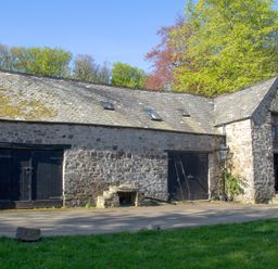 An exterior view of a stone building with two doors at Carrows Stable Morwenstow