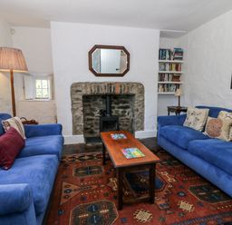 A living room with sofas and a coffee table at Dolwylan Cottage in Cwmtydu near New Quay