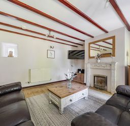 A living room with a sofa and coffee table at Tyn Y Ffynnon in Betws-Y-Coed