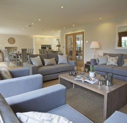 A living room with sofas and a wooden coffee table at 3 The Drive Hillfield Village in Dartmouth