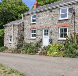 A stone house with a garden at 2 Cliff Cottages in West Portholland near Gorran Haven