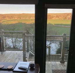 A balcony view overlooking fields and river at The Sett on the Wharfe in Skipton