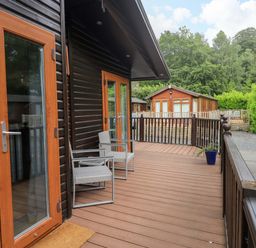An outdoor area with chairs and doors at Rydal Lodge in Grasmere 24, White Cross Bay near Windermere