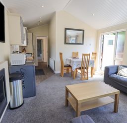 A living room with a sofa table and dining table near a kitchen area at Robin View Lodge Beckside 3 Limefitt Park near Windermere