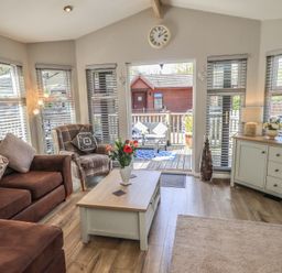 A living room with a coffee table and seating area at Badgers Hollow Lodge Grasmere 30 White Cross Bay near Windermere