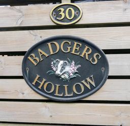 A sign that reads BADGERS HOLLOW with number 30 at Badgers Hollow Lodge, Grasmere 30, White Cross Bay near Windermere