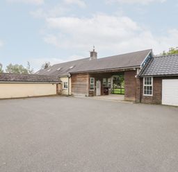 An outdoor area with a building and garage at Tynewydd Fields, Cross Inn