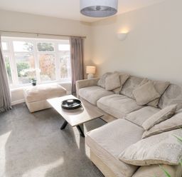 A living room with a sofa and coffee table at Westwinds in Tenby
