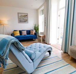 A living room with a chaise lounge and sofa at 4 The Beaches in Weymouth