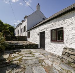 An outdoor view of a stone pathway leading to a house at Cwm, Capel Curig