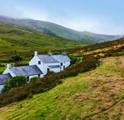 A cottage on a grassy hill at Cwm in Capel Curig