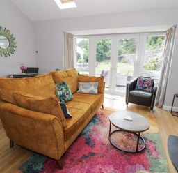 A living room with a sofa and coffee table at Pengwern Bach Llanrwst