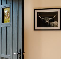An entrance with a door and a framed picture at Bramble Cottage in Akeld near Wooler