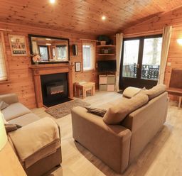 A living room with a sofa and fireplace at The Fold near Number 28, Burnside Park near Keswick