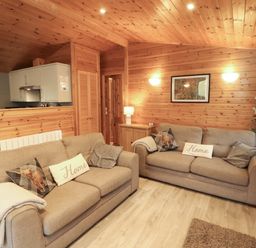 A living room with sofas and a kitchen unit at The Fold near Keswick