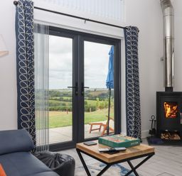 A living room with a stove and coffee table at The Cadeleigh near Tiverton