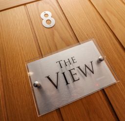 A wooden door with a number 8 and a sign that reads The View at The View in St Ives