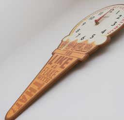 A wall clock shaped like an ice cream cone with text on the cone at Sapphire in Carbis Bay