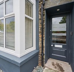 The exterior entrance door and windows of Lower Sheriff's Place in Windermere