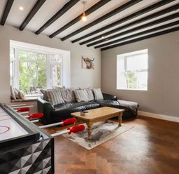 A living room with a sofa and coffee table at Tyddyn Elidir near Old Colwyn