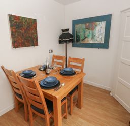 A dining room with a table set for dinner at Llys-Yr-Onnen in Carmarthen