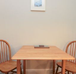A dining room with a table and two chairs at Beck View 