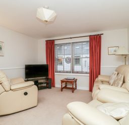 A living room with a television and seating at Derwent Haven in Keswick
