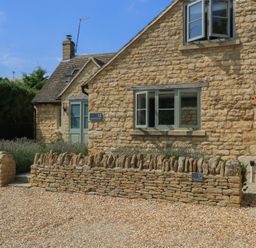 A house with stone walls and windows at 12 Manor Farm Close Kingham