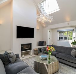 A living room with sofas and a coffee table at 12 Manor Farm Close in Kingham