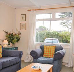 A living room with a sofa and armchair at Avoca in Rock
