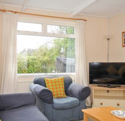A living room with a sofa and television at Avoca in Rock