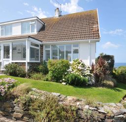 A house with garden and flowers at Sunset in Polzeath