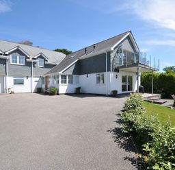 An outdoor area with a house and garage at Farlands Daymer Bay