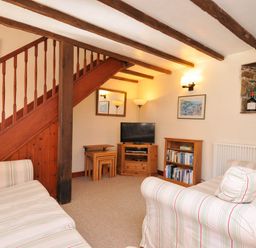 A living room with a staircase and furniture at The Granary in Rock