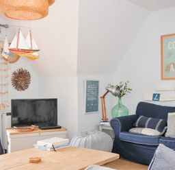 A living room with a television and a sofa at Rocklings in Rock