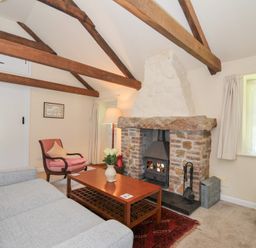 A living room with a fireplace and sofa at Mill Pond in Rock